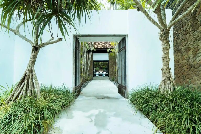 Walled entrance path leading into a private villa in Canggu, Bali
