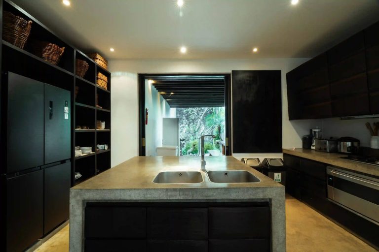 Villa kitchen with a concrete island and double sink in Bali