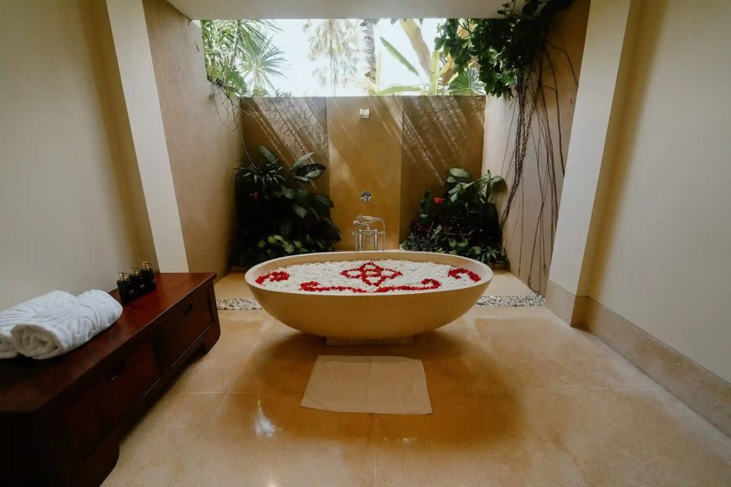 Open-air bathroom with a freestanding tub in a Bali villa