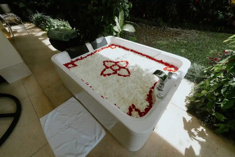 Outdoor jacuzzi decorated with flower petals at a Bali villa