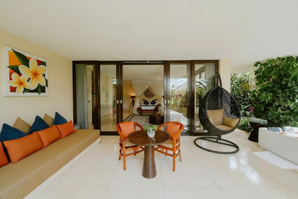 Villa suite lounge opening onto the bedroom and garden in Bali