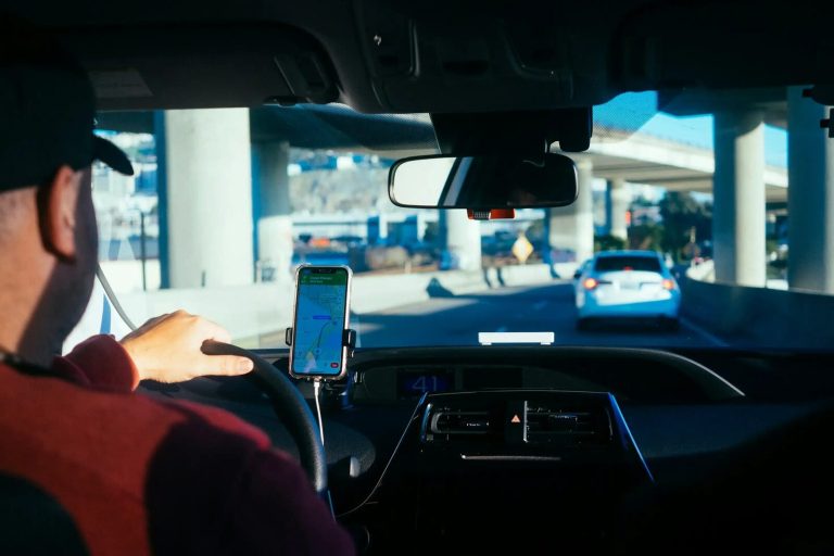 Driver following smartphone navigation on a dashboard mount