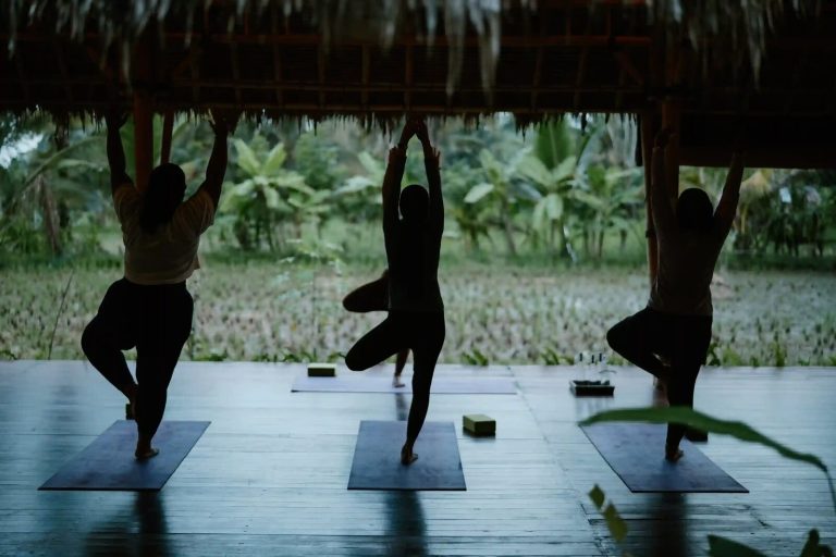 Sunset yoga session in an open-air pavilion in Ubud